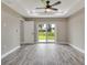 Sun-filled living room offering wood-style flooring, recessed lighting, and a ceiling fan at 271 Antis Dr, Rotonda West, FL 33947