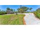 Well-maintained backyard with a stone driveway and picturesque landscaping at 285 Spaniards Rd, Placida, FL 33946