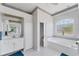 Bathroom featuring a soaking tub, glass block window, and a separate lavatory at 285 Spaniards Rd, Placida, FL 33946