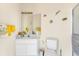 Bathroom with a white vanity, toilet, and decorative fish accents at 285 Spaniards Rd, Placida, FL 33946