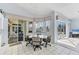 Cozy dining area with tile flooring, bright windows, and access to outdoor spaces at 285 Spaniards Rd, Placida, FL 33946
