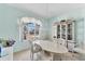 Bright dining room boasts large windows, chandelier, and a decorative cabinet at 285 Spaniards Rd, Placida, FL 33946