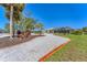 Beautiful home with a long, winding driveway, lush landscaping, and a screened-in lanai overlooking the property at 285 Spaniards Rd, Placida, FL 33946