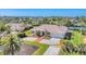 Charming Florida home features manicured lawn, palm trees, a brick-accented driveway, and a vibrant blue front door at 285 Spaniards Rd, Placida, FL 33946