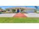 Inviting home with a brick-accented driveway, manicured lawn, and charming curb appeal in a tranquil neighborhood at 285 Spaniards Rd, Placida, FL 33946