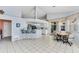 Open floor plan with eat-in kitchen, kitchen bar, tile floors, and neutral color palette at 285 Spaniards Rd, Placida, FL 33946