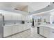 Bright kitchen with white cabinets, white countertops, tile floors, and exterior views at 285 Spaniards Rd, Placida, FL 33946