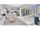 Neutral living room with tile floors, sliders to the pool area, and open floor plan at 285 Spaniards Rd, Placida, FL 33946