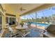 Screened patio features outdoor dining with pool and garden views at 285 Spaniards Rd, Placida, FL 33946