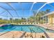Relaxing pool and jacuzzi with a screened-in lanai offering stunning backyard views at 285 Spaniards Rd, Placida, FL 33946