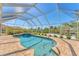 Private screened-in pool with an attached spa, surrounded by brick pavers and meticulous landscaping at 285 Spaniards Rd, Placida, FL 33946