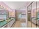 Spacious bathroom with double sinks, tiled floors, walk-in shower, and soaking tub at 365 Capstan Dr, Placida, FL 33946