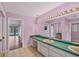 Bathroom featuring long countertop, double sinks, and an open doorway with a pool view at 365 Capstan Dr, Placida, FL 33946