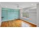 Bedroom featuring hardwood floors, a ceiling fan, open shelves, and large windows at 365 Capstan Dr, Placida, FL 33946