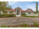 Stunning home featuring a red-tiled roof, arched windows, and a grand entrance, surrounded by lush landscaping at 365 Capstan Dr, Placida, FL 33946
