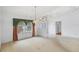 Bright living room with an arched window, hanging light fixtures, and tiled floors at 365 Capstan Dr, Placida, FL 33946