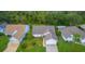 An aerial view of a well-maintained home with lush landscaping and a serene setting amongst mature trees at 399 Blue Springs Ct # 203, Englewood, FL 34223