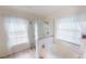 Bright bathroom with stand alone tub, glass shower, and neutral decor at 399 Blue Springs Ct # 203, Englewood, FL 34223