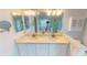 Bright bathroom with double vanity, stand alone tub, glass shower, and neutral decor at 399 Blue Springs Ct # 203, Englewood, FL 34223