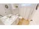 Clean, white bathroom features a marble countertop, neutral tile floor, and shower with curtain at 399 Blue Springs Ct # 203, Englewood, FL 34223