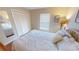 Bright bedroom features a large closet, window and a comfy bed with yellow accents at 399 Blue Springs Ct # 203, Englewood, FL 34223