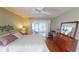 Charming bedroom with wood floors, neutral paint, a ceiling fan, and natural light at 399 Blue Springs Ct # 203, Englewood, FL 34223