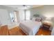 Cozy bedroom with wood floors, neutral paint, and bright, natural light at 399 Blue Springs Ct # 203, Englewood, FL 34223