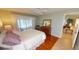 Bedroom features wood floors, neutral paint, a ceiling fan, and bright, natural light at 399 Blue Springs Ct # 203, Englewood, FL 34223