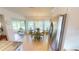 Cozy breakfast nook with large window views and adjacent stainless steel refrigerator at 399 Blue Springs Ct # 203, Englewood, FL 34223