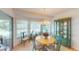 Charming dining area with chandelier lighting and views to screened lanai at 399 Blue Springs Ct # 203, Englewood, FL 34223