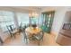 Bright dining room features a round table, chandelier lighting, and a decorative china cabinet at 399 Blue Springs Ct # 203, Englewood, FL 34223