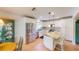 Contemporary kitchen featuring white cabinetry, stainless steel appliances, and marble countertops at 399 Blue Springs Ct # 203, Englewood, FL 34223