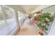 Light-filled lanai with tiled floors, ceiling fan and sliding glass doors leading to the interior at 399 Blue Springs Ct # 203, Englewood, FL 34223