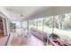 Enclosed lanai with large windows, tile flooring, ceiling fans and views of the lush backyard at 399 Blue Springs Ct # 203, Englewood, FL 34223