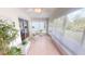 Cozy screened in lanai with a comfortable chair and tile flooring to enjoy the outdoors at 399 Blue Springs Ct # 203, Englewood, FL 34223