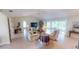 Spacious living room with tile floors, comfortable seating, and a view to the screened lanai at 399 Blue Springs Ct # 203, Englewood, FL 34223