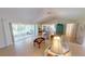 A sunlit living space with vaulted ceilings, tile floors and leads out to a screened-in lanai with nature views at 399 Blue Springs Ct # 203, Englewood, FL 34223