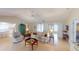 Bright living room with tile flooring, neutral-toned furnishings, and a ceiling fan at 399 Blue Springs Ct # 203, Englewood, FL 34223