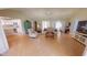Open-concept design with tile floors, a vaulted ceiling, and views into the kitchen provide an airy atmosphere at 399 Blue Springs Ct # 203, Englewood, FL 34223
