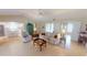 Spacious living room with tiled flooring, a ceiling fan, and an open floor plan with views of the kitchen at 399 Blue Springs Ct # 203, Englewood, FL 34223