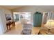 Open-concept living area with tile floors that seamlessly connects to the kitchen and adjoining screened in lanai at 399 Blue Springs Ct # 203, Englewood, FL 34223