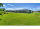 Expansive backyard with well-maintained lawn and screened-in pool, offering a perfect space for outdoor activities at 423 Boundary Blvd, Rotonda West, FL 33947
