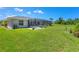 Backyard features a screened pool, patio, and lush green grass, perfect for outdoor enjoyment and relaxation at 423 Boundary Blvd, Rotonda West, FL 33947
