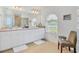 Bright bathroom features double sinks, tile flooring, and abundant natural light at 423 Boundary Blvd, Rotonda West, FL 33947