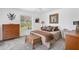Stylized bedroom with a comfortable bed, soft carpet, and natural light from the large window at 423 Boundary Blvd, Rotonda West, FL 33947
