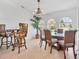 Inviting dining room featuring a chandelier, tile flooring and a window with natural light at 423 Boundary Blvd, Rotonda West, FL 33947