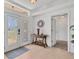 Bright foyer features tile flooring, decorative table, and an elegant front door at 423 Boundary Blvd, Rotonda West, FL 33947