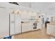 Well-lit kitchen featuring white cabinetry, tile floor, and modern appliances at 423 Boundary Blvd, Rotonda West, FL 33947