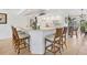 Bright kitchen features counter seating, white cabinetry, and tile flooring at 423 Boundary Blvd, Rotonda West, FL 33947