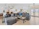 Open concept living room featuring tile flooring, plenty of seating, and a large entertainment center at 423 Boundary Blvd, Rotonda West, FL 33947